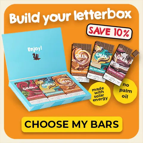 Chocolate bar "Build your letterbox" with 'Enjoy!' packaging on an orange background, featuring promotional text and graphics.