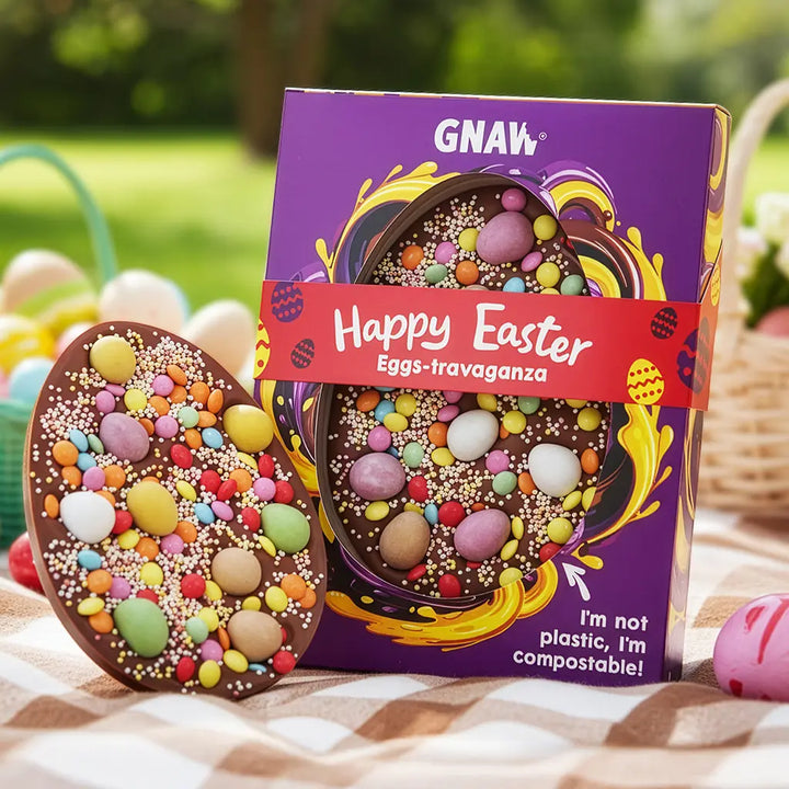 Easter-themed chocolate eggs with GNAW branded packaging on a checkered cloth outdoors.