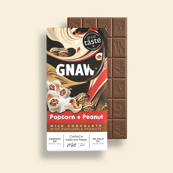 Product shot of GNAW Popcorn + Peanut chocolate bar with Great Taste Award logo and open bar behind