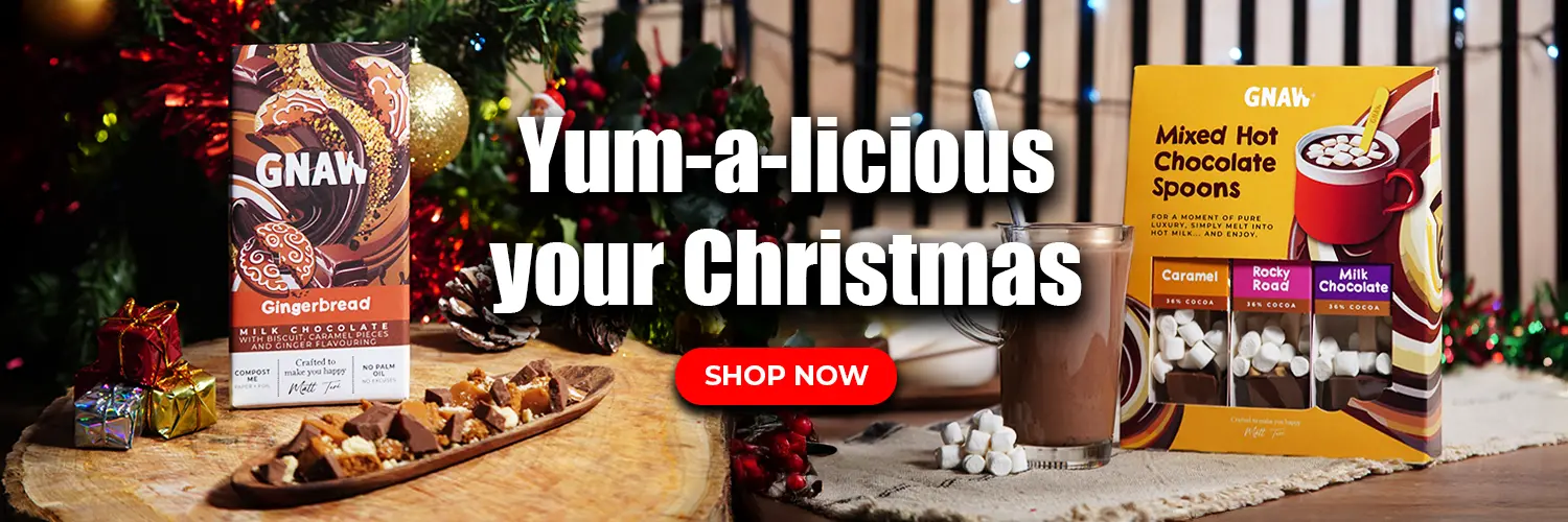 Promotional banner for Christmas-themed products with 'GNAW' chocolate bar and Hot Chocolate Spoons packaging.